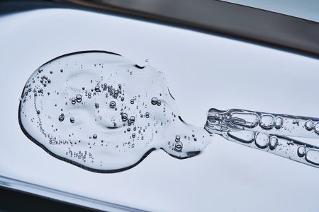 The texture of the serum with bubbles spilling onto the blue surface.の写真素材