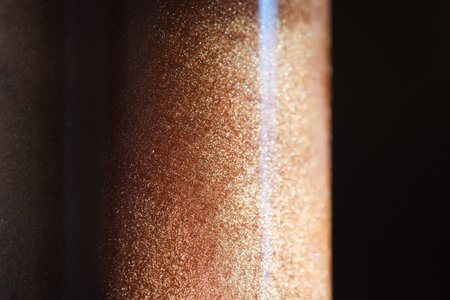 A bottle of body bronzer with glitter.