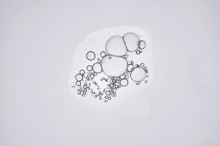 The texture of a cosmetic product with bubbles on a gray background.