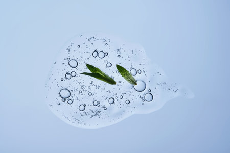 A drop of shampoo with bubbles. A texture with a leaf in it.