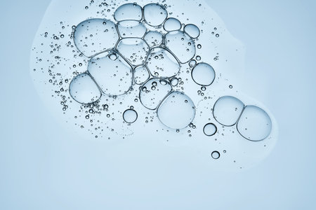 A beautiful drop of cosmetic product with bubbles on a blue background.