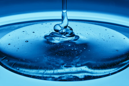 The texture of a cosmetic product in the form of jelly or gel on a blue background.の写真素材
