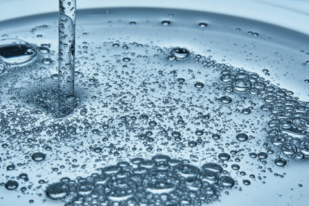 Shampoo or shower gel is poured from above and shows a bubbly texture.の写真素材