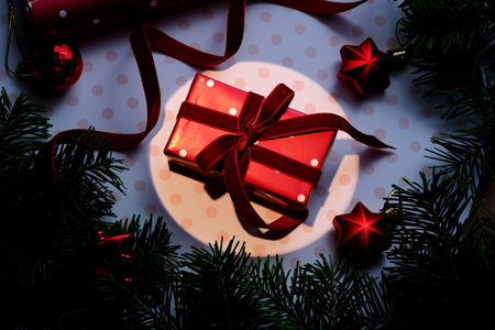 A Christmas background with a red polka dot gift.の写真素材