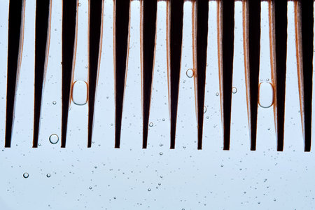 A comb with hair serum. The photo shows the texture of the cosmetic product.