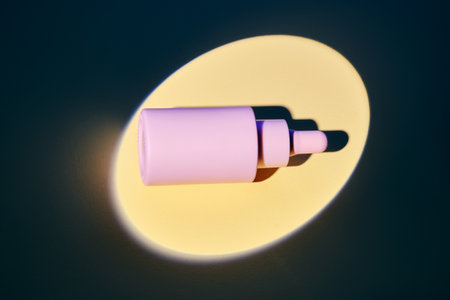 Bottles of facial serum on a golden background in the spotlight.の写真素材