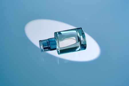A spray bottle with hair mist or perfume on a blue background.の写真素材