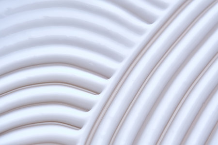 Beautiful waves of cream close-up. Beauty background.の写真素材
