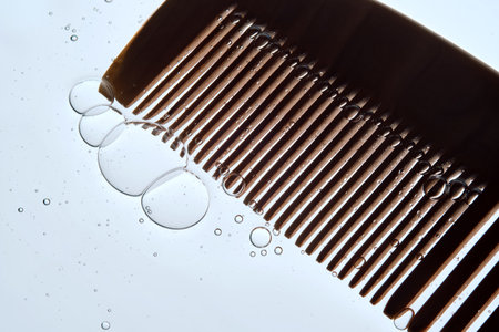 A comb with hair serum. The photo shows the texture of the cosmetic product.の写真素材