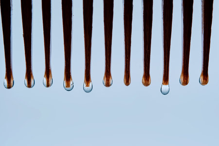 A comb with hair serum. The photo shows the texture of the product.の写真素材