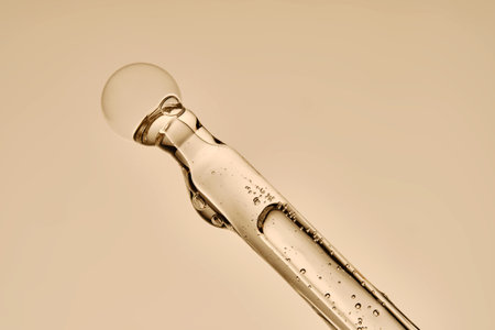 The texture of the hyaluronic serum flowing down the dropper.の写真素材