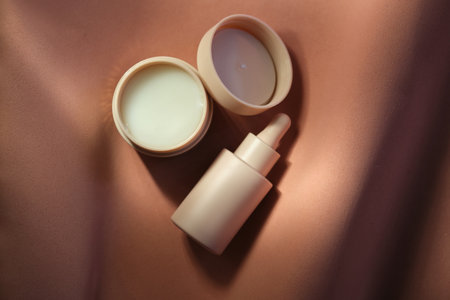 Face cream and serum on a soft beige background.の写真素材