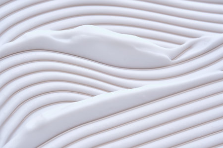 Beautiful waves of cream close-up. Beauty background.の写真素材