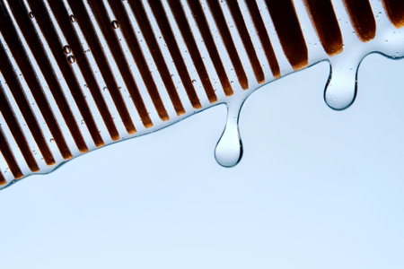A comb with hair serum. The photo shows the texture of the cosmetic product.の写真素材