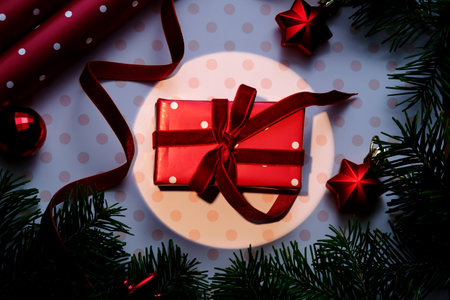 A Christmas background with a red polka dot gift.の写真素材
