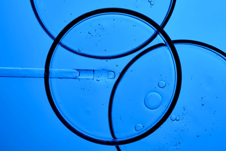The texture of the serum with PDRN in a petri dish on a blue background.