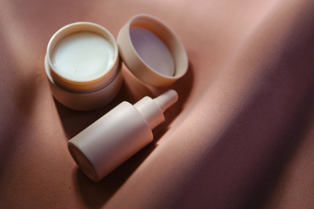 Face cream and serum on a soft beige background.の写真素材