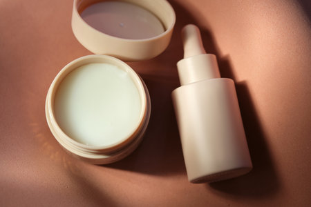 Face cream and serum on a soft beige background.の写真素材