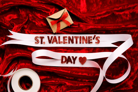 Festive background with the words St. Valentines Day with red velvet and white ribbon.の写真素材