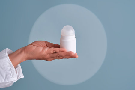 Hand holding roll-on deodorant personal hygiene productの写真素材