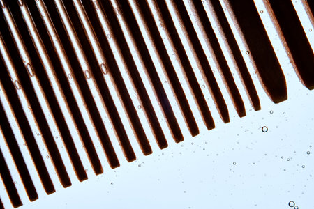 A comb with hair serum. The photo shows the texture of the cosmetic product.の写真素材