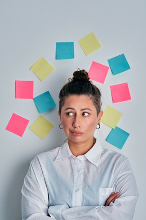 Woman brainstorming business ideas with sticky notesの写真素材