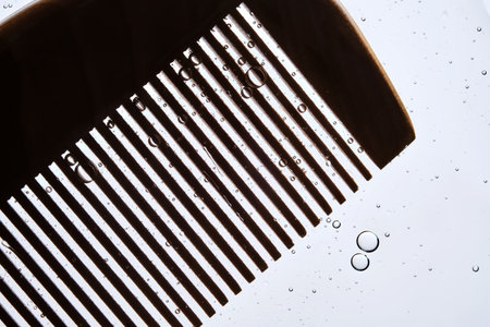 A comb with hair serum. The photo shows the texture of the cosmetic product.