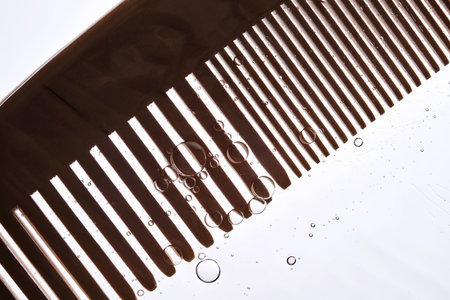 A comb with hair serum. The photo shows the texture of the cosmetic product.の写真素材