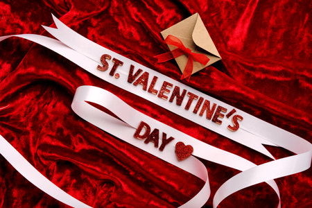 Festive background with the words St. Valentines Day with red velvet and white ribbon.の写真素材
