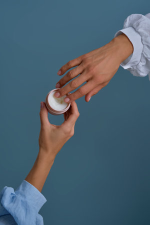 Hands sharing skincare cream for beauty and self-careの写真素材