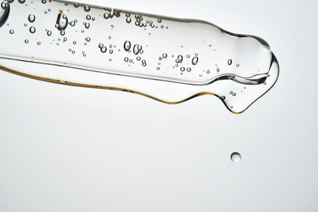 Cosmetic pipette dropping liquid serum with bubblesの写真素材