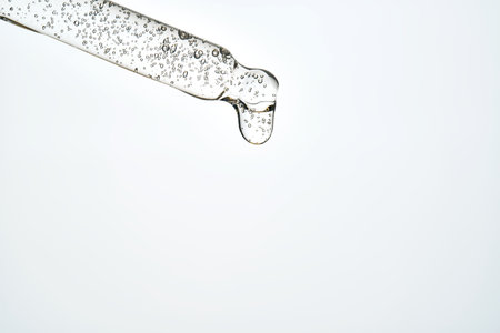 Cosmetic pipette dispensing serum drop for skincare routine