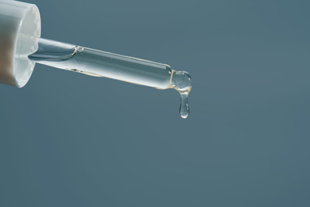 Cosmetic pipette dispensing serum drops for skincare routineの写真素材