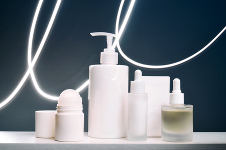 Skincare product packaging with serum and dispenser on white shelfの写真素材