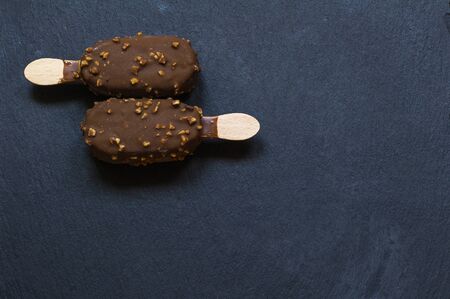 Chocolate and almond ice cream on black background