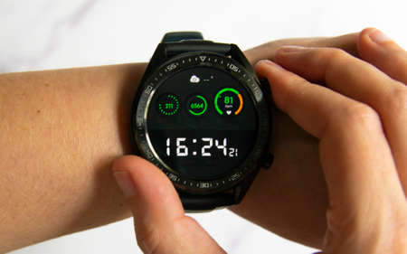 Close-up of a person wearing a smartwatch. Concept of using new technologies. Horizontal photographyの写真素材