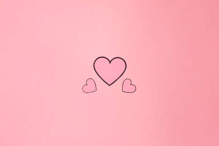 Overhead shot of several pink hearts on a background of the same color. Background for Valentine's day. Horizontal photography and copy spaceの写真素材