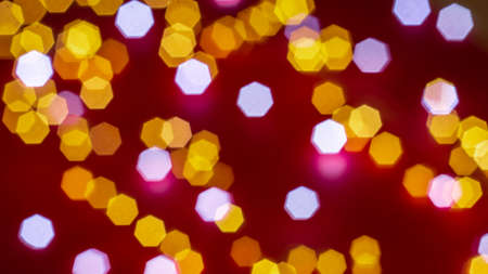 Background of defocused lights of different colors on red background. Abstract image. Valentine, love, passion and party conceptの写真素材