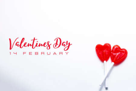 Two intertwined heart-shaped lollipops. Valentine and romantic love concept.