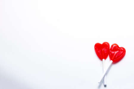 Zenith plane. Two intertwined heart-shaped lollipops. Valentine and romantic love concept.の写真素材