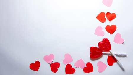 Zenith plane. White background with red and pink hearts with two heart-shaped lollipops. Valentine...