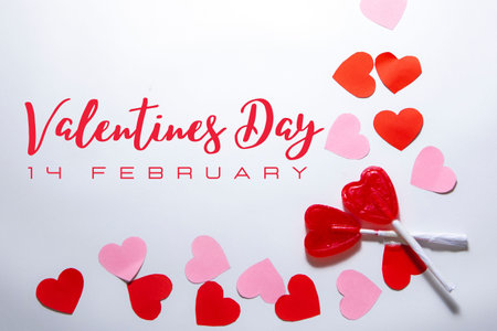 Zenith plane. White background with red and pink hearts with two heart-shaped lollipops. Valentine and romantic love concept. Textの写真素材