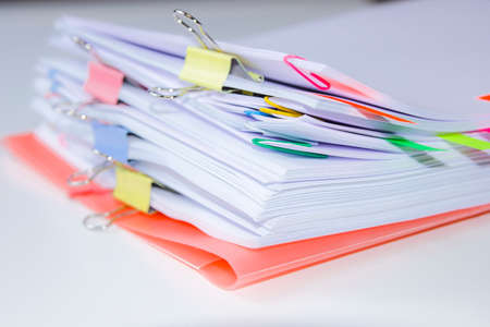 Close-up of a set of sheets attached by clips and clamps. Horizontal photography. Information overload conceptの写真素材