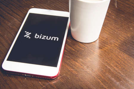 Spain. 02, 03, 2021. Overhead shot of a smartphone with the Bizum application home screen. Instant payment concept with smartphoneのeditorial素材