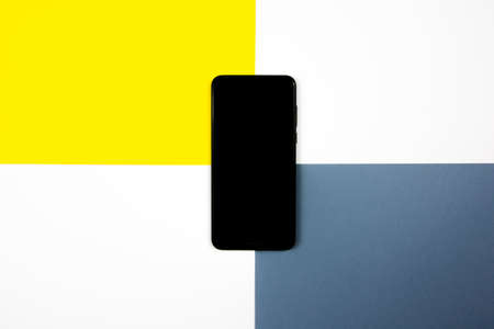 Mock up of a smartphone on different colored backgrounds.の写真素材