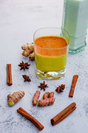 Ingredients for making golden milk or turmeric latte: Turmeric, ginger, cinnamon, milk and star anise. Concept of natural medicinal and homeopathy. Copy Spaceの写真素材