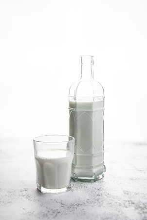 Glass and glass bottle filled with milk. Simple and simple photography. Healthy eating concept. Copy Spaceの写真素材