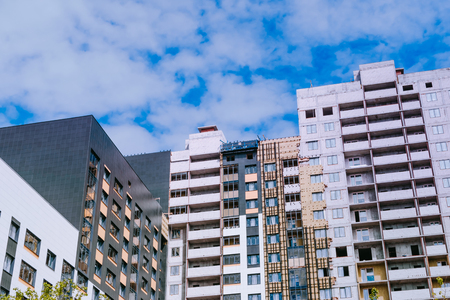 Multi-storey buildings under construction on a blue skyの写真素材