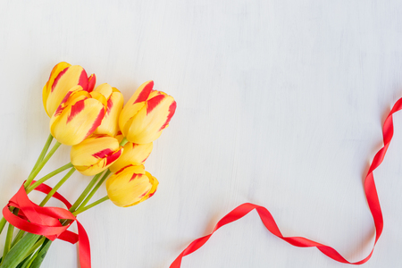 Yellow tulips flowers on a light background empty space for your text, top viewの写真素材