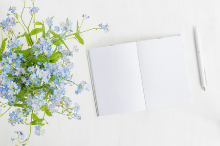Mockup notebook with blue flowers and light backgroundの写真素材